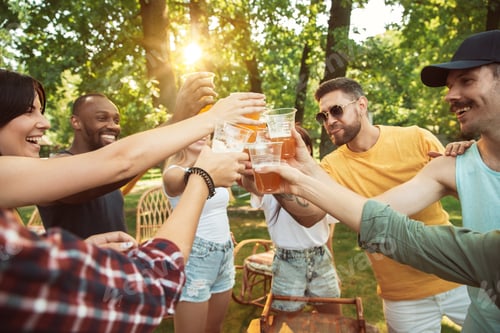 Preview: Happy friends are having beer and barbecue party at sunny day