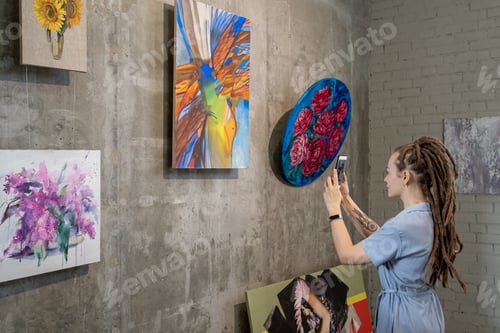 Preview: Woman photographing paintings in the phone