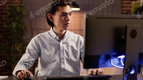 Preview: Focused asian man working on commercial report on website