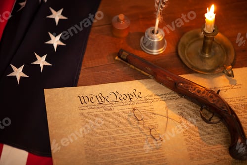 Preview: Selective focus view of constitution of United States with 13 star flag pistol candle and quill