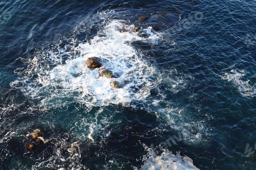 Preview: Sea surface with stones near coast top view