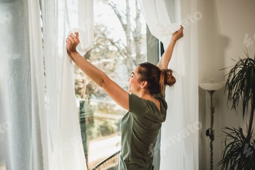 Preview: Woman Enjoying View Through The Window In The Morning Sunshine