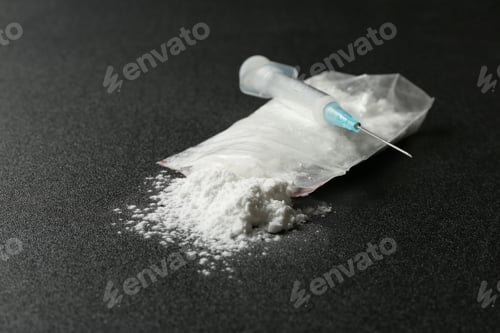 Preview: Cocaine in plastic bag and syringe on dark background