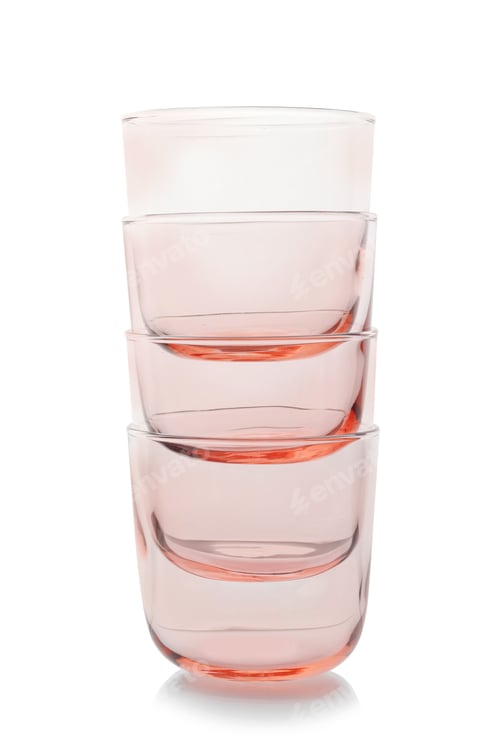 Preview: Stack of empty colorful whiskey glasses on white background