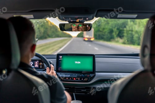 Preview: A male driver drives at speed through the streets of the city.
