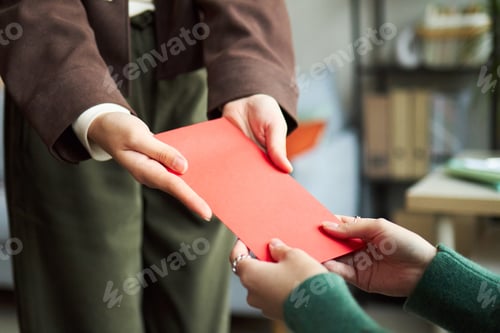 Preview: Young Asian Businesswoman Handing Red Envelope to Young Asian Businesswoman