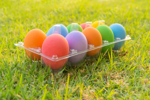 Preview: Colorful easter eggs on natural green grass background. Food decoration on holiday.