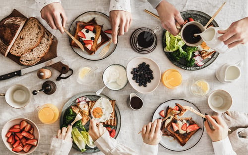 Preview: People having breakfast with coffee and snacks over white table