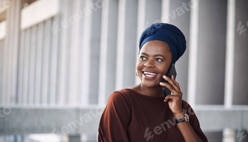 Preview: Shot of a young businesswoman using a smartphone against a city background