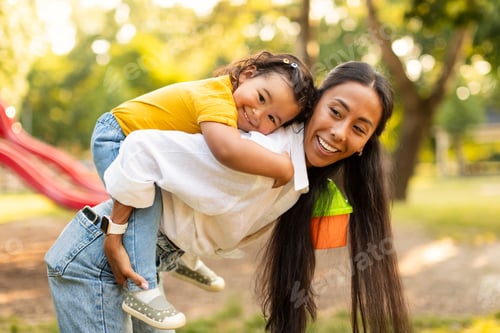 Preview: Happy Chinese Mother Giving Piggyback Ride To Baby Outdoors