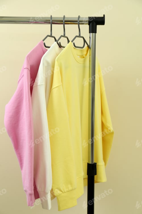 Preview: Wardrobe rack with sweatshirts against beige background