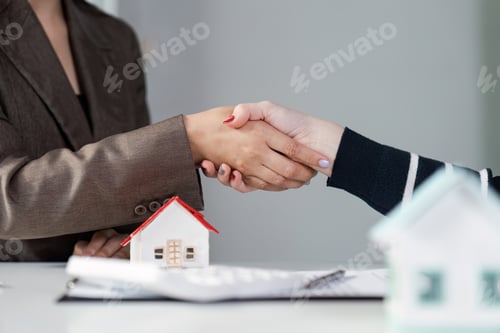 Preview: Handshake between real estate agent and client after signing contract.