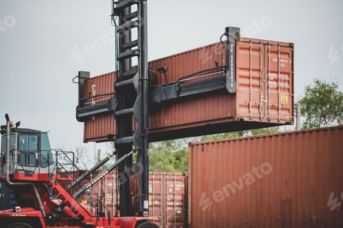 Vista previa: Forklift truck lifting cargo container in shipping yard or dock yard with cargo container stack