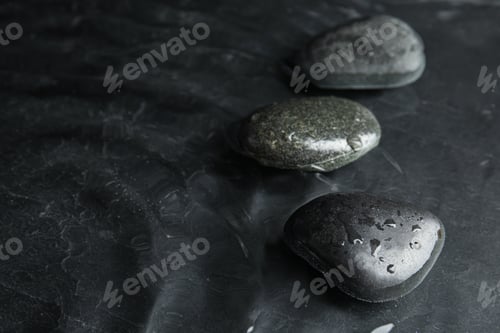 Preview: Stones in water on dark background, space for text. Zen lifestyle