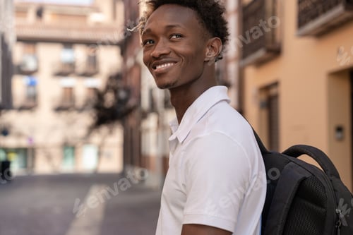 Preview: Young student smiling walking in the street