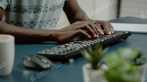 Preview: Close up of hands using computer keyboard and listening to music