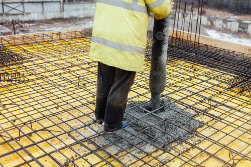 Preview: Male builder pours concrete with a pump
