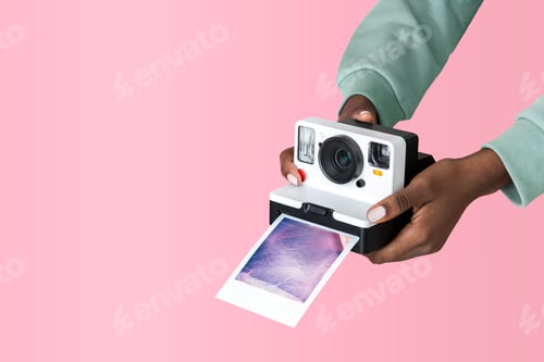 Preview: Hands holding an instant camera