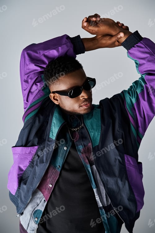 Preview: Stylish African American Man Strikes Pose in Purple Jacket