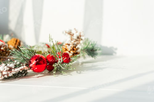 Preview: Christmas twig on a white wooden background