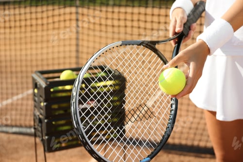 Preview: Sportswoman preparing to serve tennis ball at court, closeup