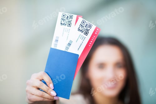 Preview: Image of European Woman Having Beautiful Brown Hair Smiling While Holding Passport and Air Tickets