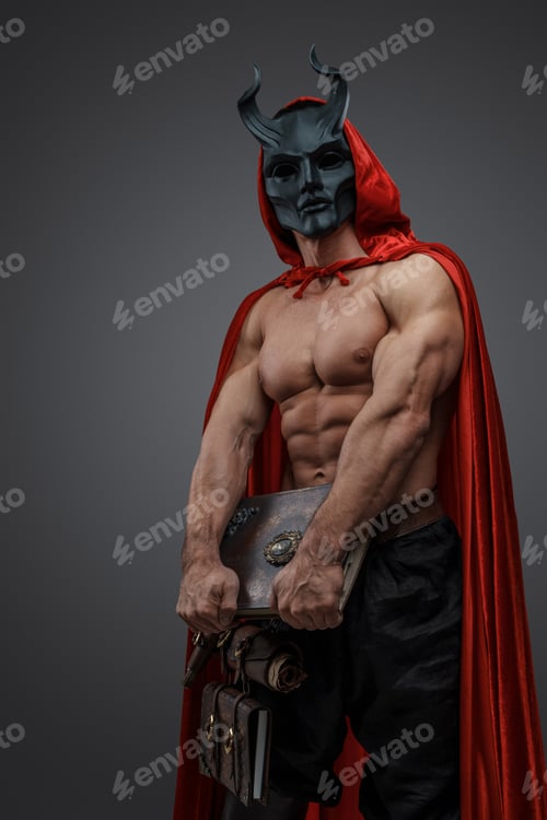 Preview: Mystic fanatic with mask holding book against gray background