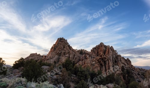 Preview: Dry rocky desert mountain landscape with trees. Sunny Sunset Sky