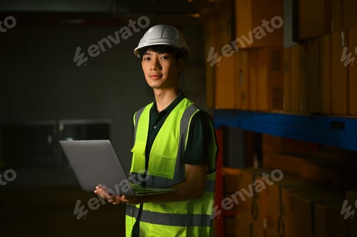 Preview: Portrait of male warehouse worker aisle between rows of tall shelves full of packed boxes