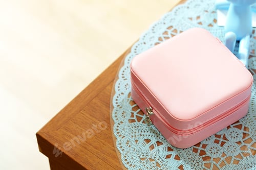 Preview: Elegant Pink Jewelry Box on a Lace Doily and Wooden Surface in Soft Daylight