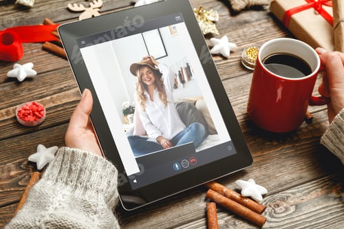 Preview: online greeting with christmas digital tablet in hand