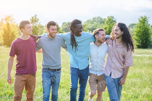 Preview: Group of boys of different nationalities hanging out together in the park enjoying good weather