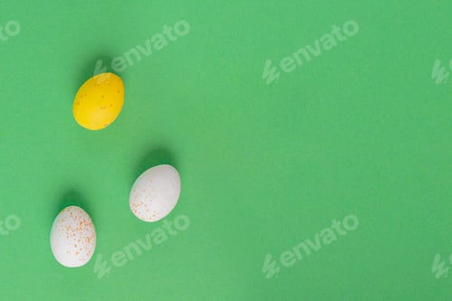 Preview: Minimalistic easter background of chocolate candy yellow and white eggs