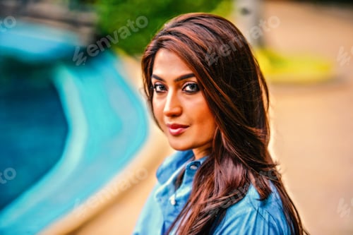 Preview: Beautiful model sitting beside pool