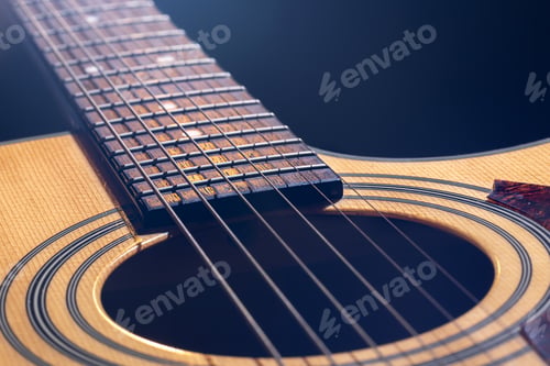 Preview: Close-up of a guitar fretboard on a blurred background.
