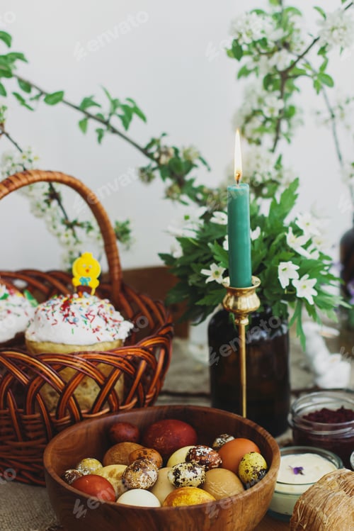 Preview: Traditional Easter food, homemade Easter bread, easter eggs and spring flowers on rustic table