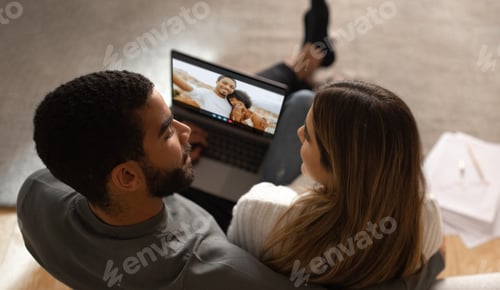 Preview: Couple Video Chatting With Friends On Laptop At Home