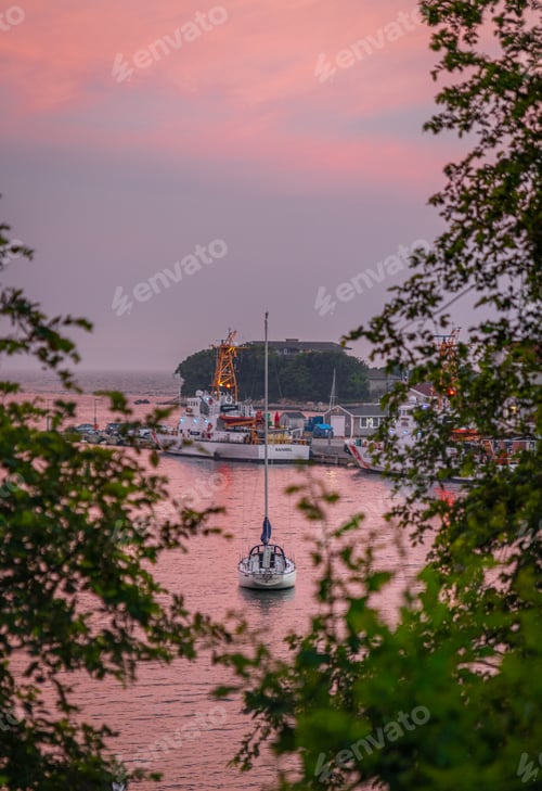 Preview: Vertical shot of boats in a harbor at sunset in Cape Cod, USA