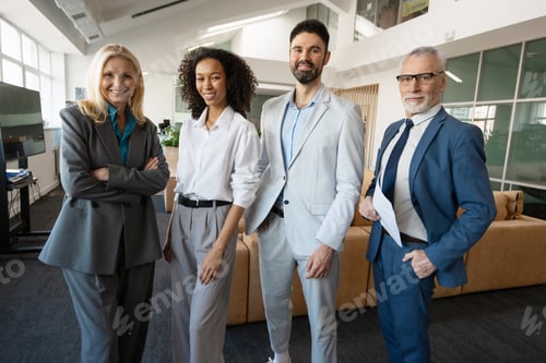 Preview: Smiling business people posing together in modern office