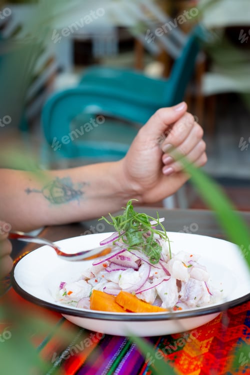 Preview: Girl eating fish ceviche. Peruvian food restaurant.