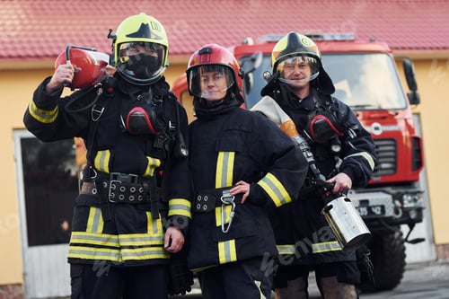 Preview: Group of firefighters in protective uniform that outdoors near truck