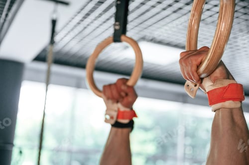 Preview: Close up view of strong man that is using athlete rings