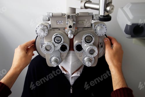 Preview: Ophthalmologist uses eyepiece to examine patient's eyes