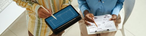 Preview: Coworkers Discussing Chart on Tablet