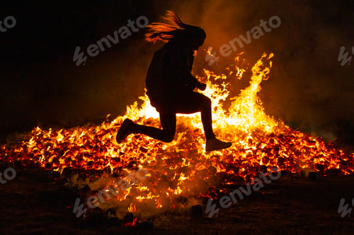 Preview: Summer solstice celebration jumping into the fire. Burning flames