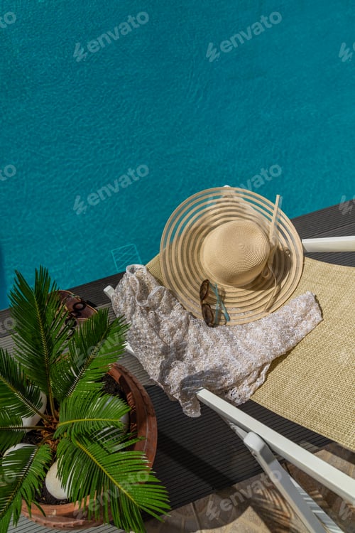 Preview: woman in luxury spa resort near the swimming pool.