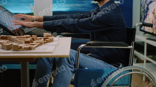 Preview: Architect with disability analyzing building model