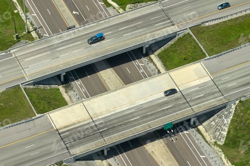 Preview: Aerial view of freeway overpass junction with fast moving traffic cars and trucks.