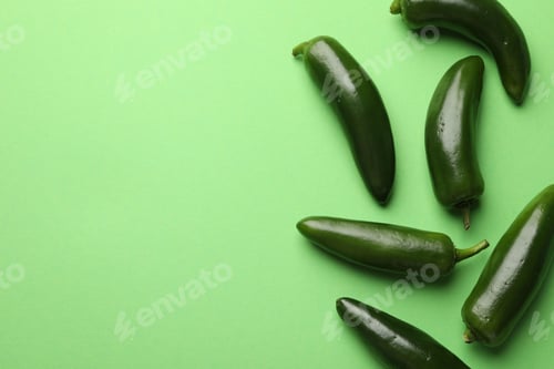Preview: Ripe jalapeno peppers on light green background, flat lay. Space for text