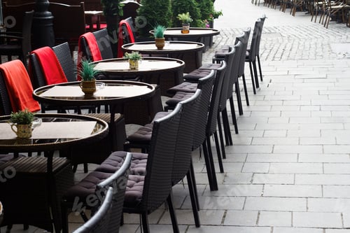 Preview: Chairs and tables on the terrace of a restaurant in the afternoo